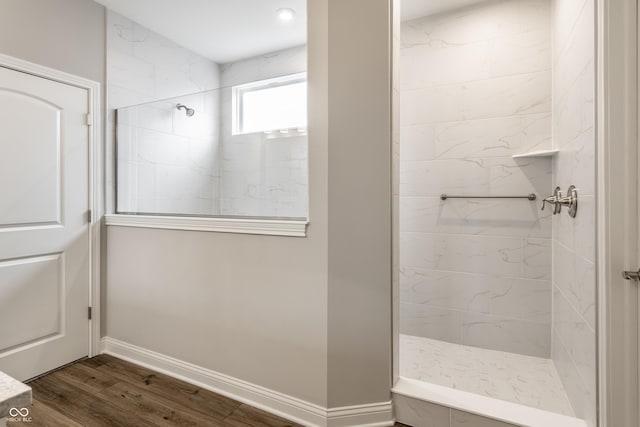 804 Whispering Oaks Dr, Carmel, IN 46032 - bathroom with tiled shower, wood finished floors, and baseboards