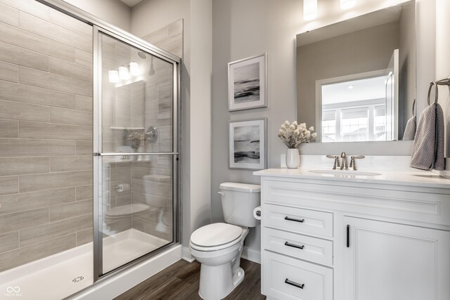 804 Whispering Oaks Dr, Carmel, IN 46032 - full bath featuring toilet, vanity, a shower stall, and wood finished floors