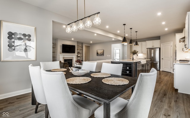 804 Whispering Oaks Dr, Carmel, IN 46032 - dining space with dark wood-style flooring, a fireplace, recessed lighting, baseboards, and built in features