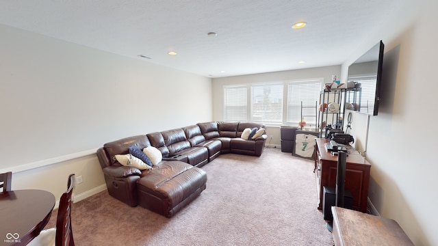 carpeted living area featuring visible vents, baseboards, and recessed lighting