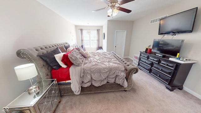 bedroom featuring light colored carpet, ceiling fan, visible vents, and baseboards