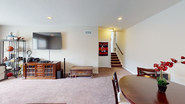 living area with recessed lighting, carpet floors, visible vents, baseboards, and stairs