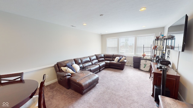 living area with carpet floors, recessed lighting, visible vents, and baseboards