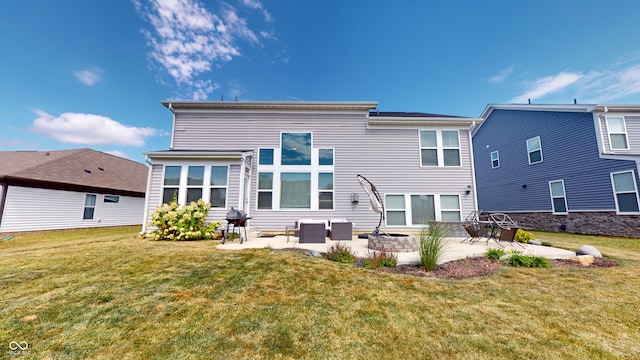 rear view of property featuring a fire pit, a lawn, and a patio area