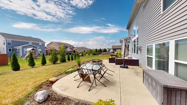 view of patio / terrace featuring a fire pit, fence, and a residential view