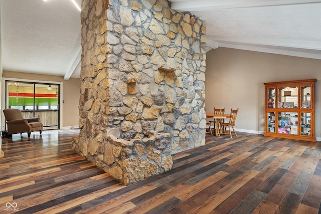 hall featuring lofted ceiling with beams, baseboards, and wood finished floors