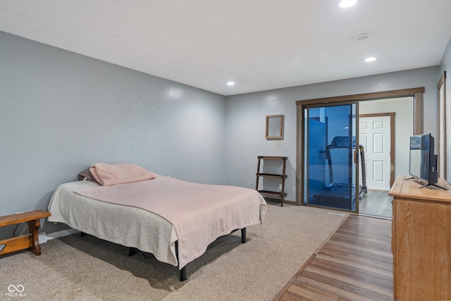 bedroom featuring baseboards, access to outside, wood finished floors, and recessed lighting