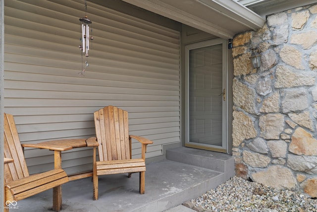 doorway to property featuring stone siding