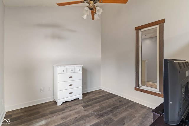 unfurnished bedroom featuring dark wood-style floors, ceiling fan, and baseboards