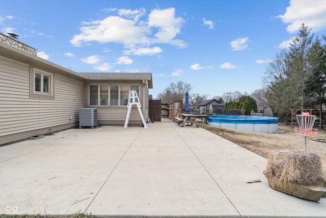 view of pool featuring a patio, cooling unit, a fenced in pool, and fence