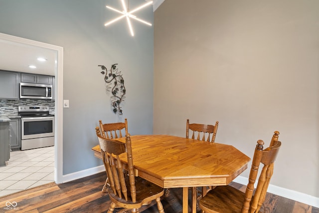 dining space with light wood-style flooring and baseboards