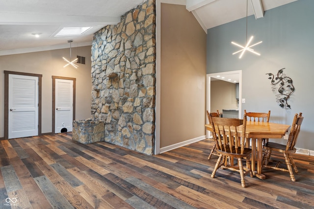 dining space with a chandelier, beam ceiling, wood finished floors, and visible vents