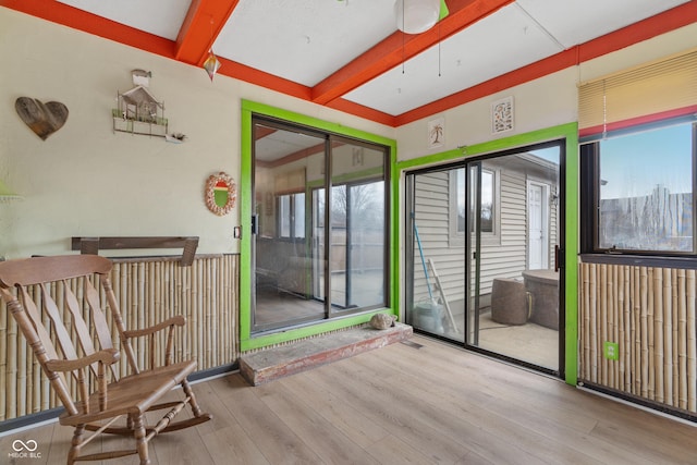 sunroom featuring a wealth of natural light and beam ceiling