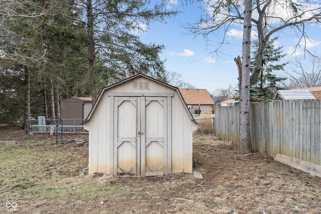 view of shed featuring fence