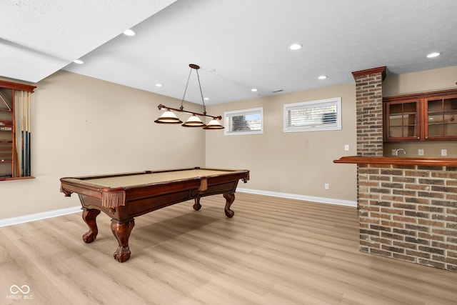 game room with recessed lighting, indoor wet bar, light wood-style flooring, and baseboards