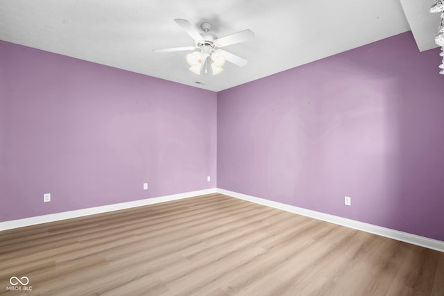 unfurnished room featuring ceiling fan, baseboards, and wood finished floors