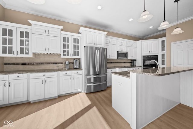 kitchen featuring white cabinets, black appliances, ornamental molding, and light wood finished floors