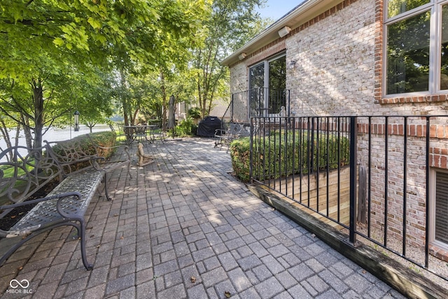 view of patio with outdoor dining space and fence