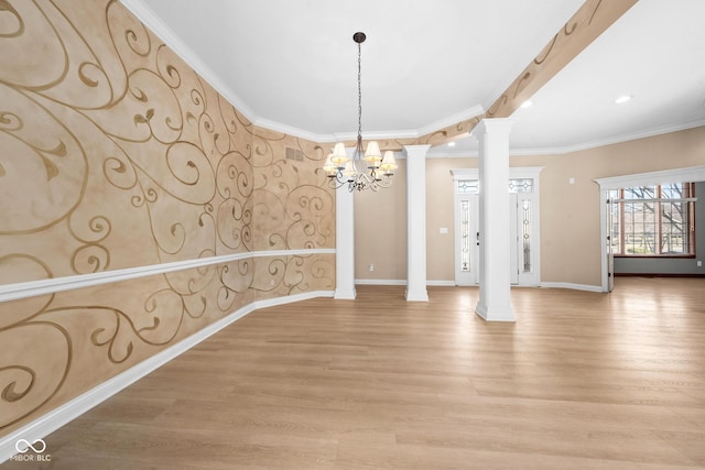 spare room with light wood-style floors, baseboards, and ornate columns