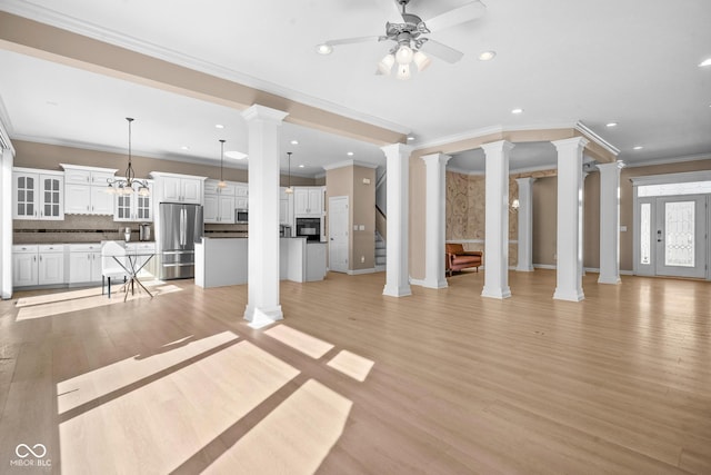 unfurnished living room with light wood finished floors, decorative columns, ceiling fan, and recessed lighting