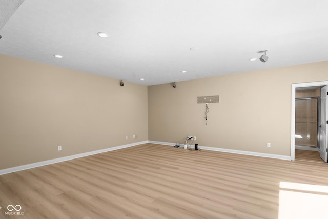 spare room with recessed lighting, light wood-style flooring, and baseboards