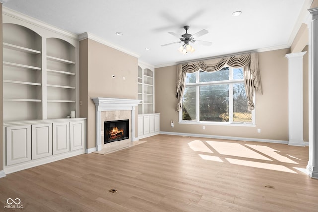 unfurnished living room featuring light wood-type flooring, ornamental molding, a fireplace, and baseboards