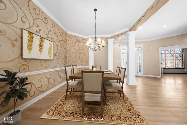 dining space with light wood-type flooring, baseboards, crown molding, and ornate columns