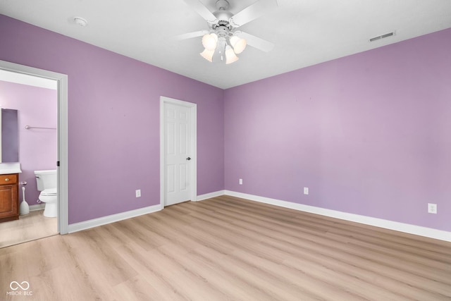 unfurnished bedroom with ensuite bathroom, ceiling fan, visible vents, baseboards, and light wood finished floors