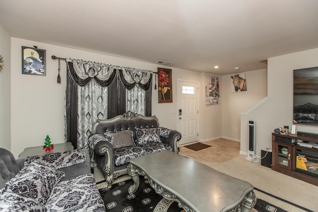 carpeted living room featuring visible vents and baseboards