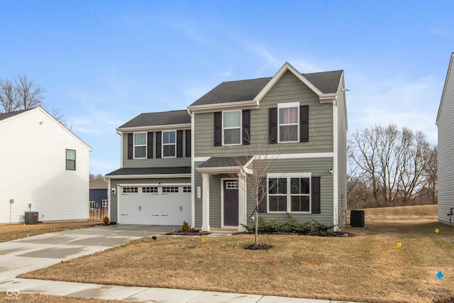 traditional-style house featuring a garage, driveway, and central AC unit