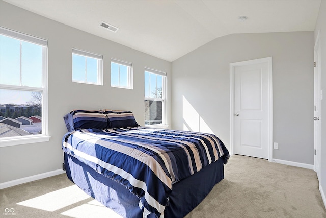 bedroom with lofted ceiling, carpet flooring, baseboards, and visible vents