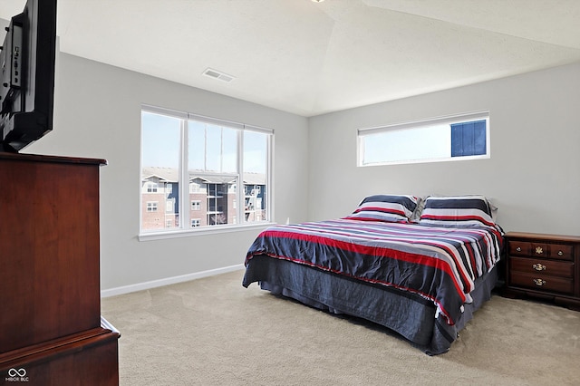 carpeted bedroom with visible vents and baseboards