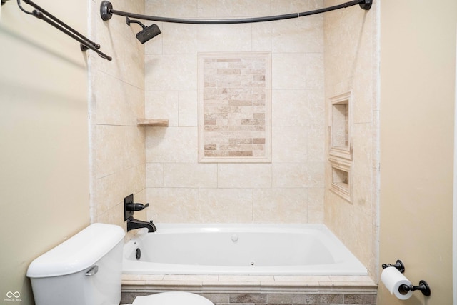 full bath featuring tiled shower / bath and toilet