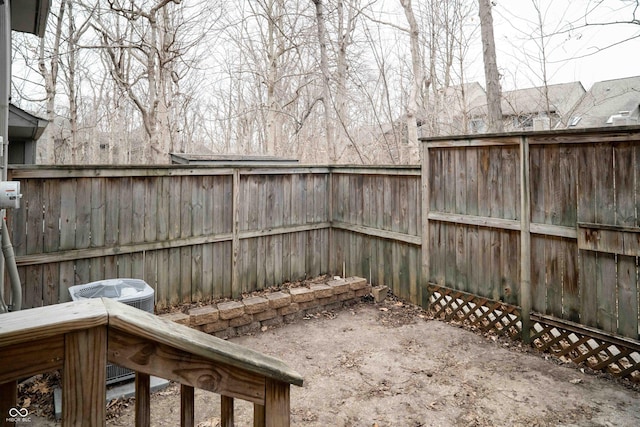 view of yard with a fenced backyard and central AC