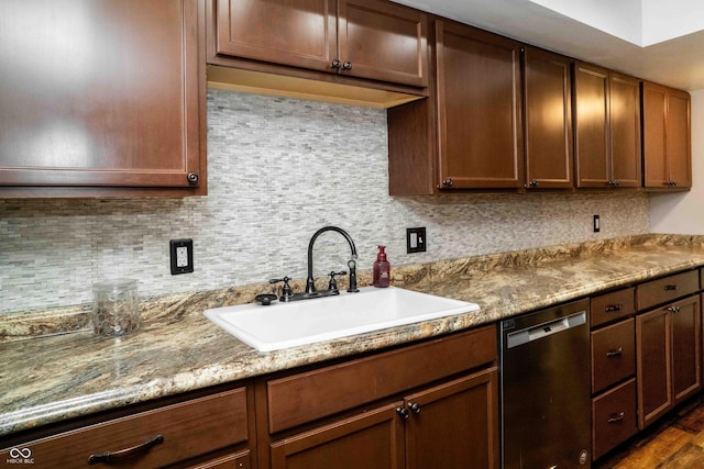 kitchen featuring tasteful backsplash, dishwasher, a sink, and dark wood-style floors