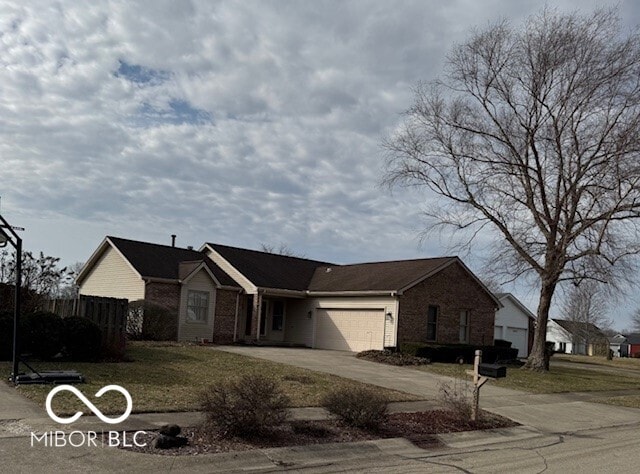 ranch-style house with concrete driveway, brick siding, fence, and an attached garage