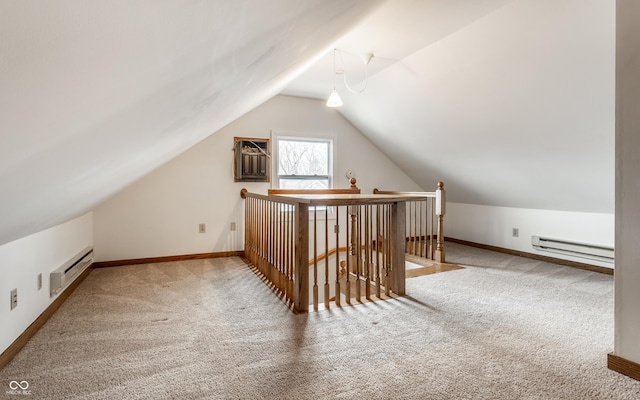 additional living space featuring a baseboard heating unit, carpet, and vaulted ceiling