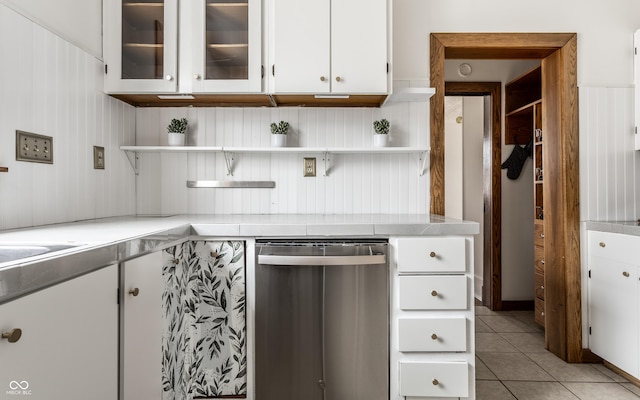 kitchen with open shelves, light countertops, white cabinets, light tile patterned flooring, and dishwasher