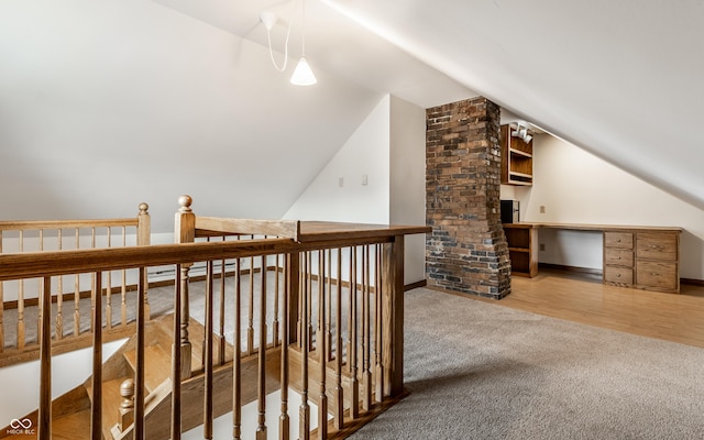 bonus room featuring vaulted ceiling, carpet, and wood finished floors