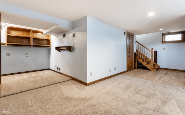 interior space featuring baseboards, visible vents, carpet, stairs, and recessed lighting