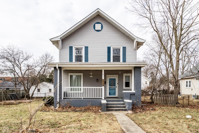 view of front of house featuring covered porch and fence