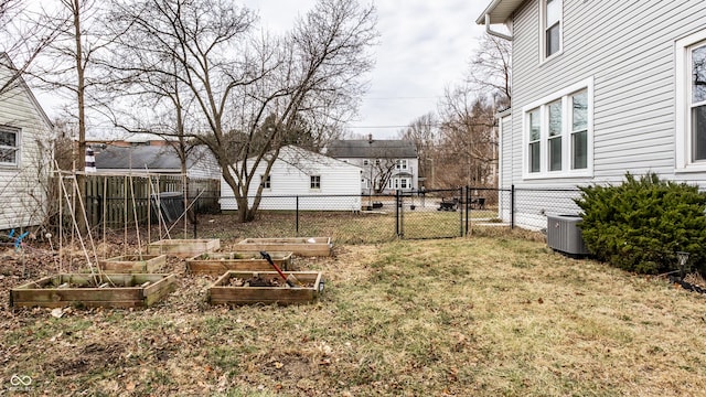 view of yard with fence, a vegetable garden, a gate, and central air condition unit