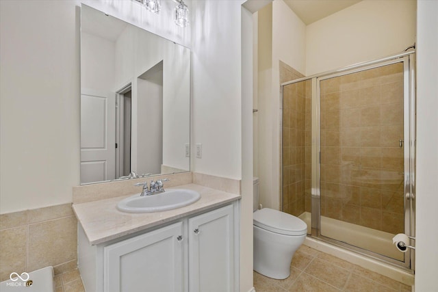 full bath featuring a stall shower, tile patterned flooring, vanity, and toilet