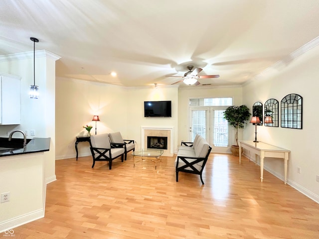 355 E Ohio St E Unit 206, Indianapolis, IN 46204 - living room featuring ceiling fan, light wood-style flooring, crown molding, baseboards, and a fireplace