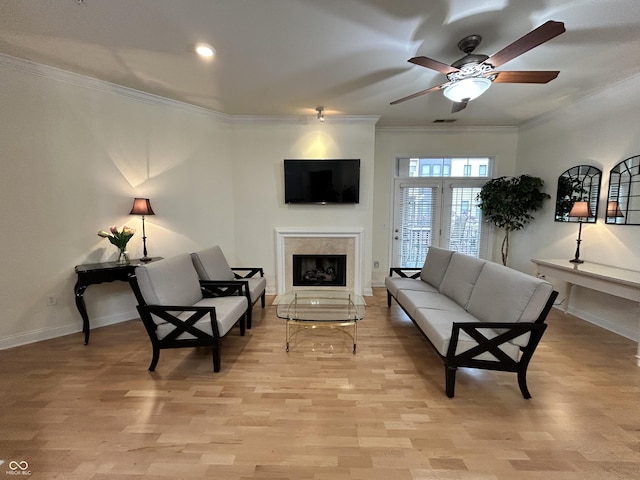 355 E Ohio St E Unit 206, Indianapolis, IN 46204 - living room featuring ornamental molding, a fireplace, a ceiling fan, light wood finished floors, and baseboards