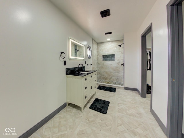 hallway featuring a sink and baseboards