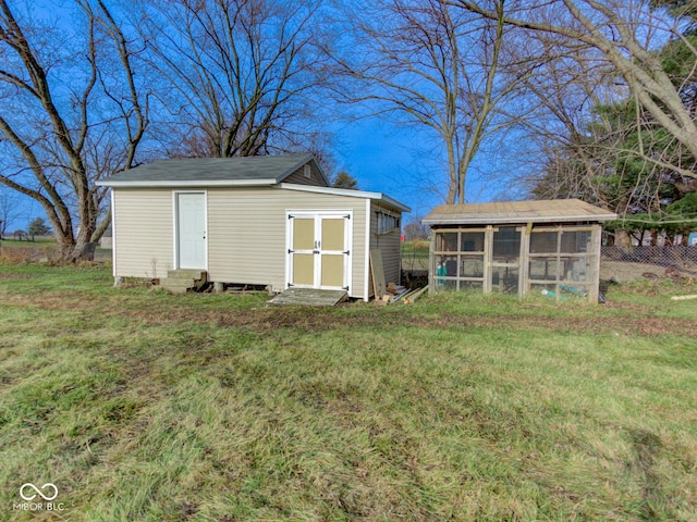 view of poultry coop featuring entry steps, a yard, and fence