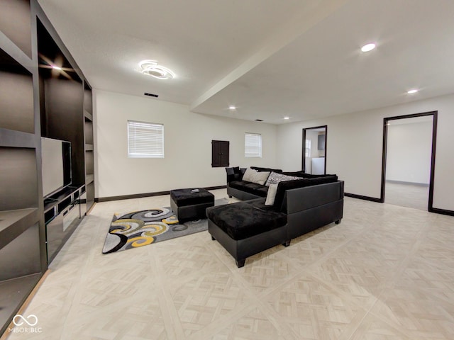 living area featuring electric panel, recessed lighting, visible vents, and baseboards