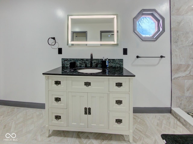 bathroom featuring baseboards and vanity