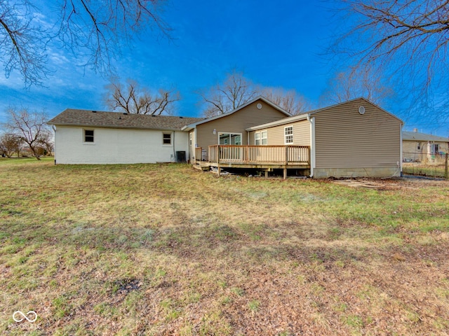 rear view of house featuring cooling unit, a lawn, a deck, and fence